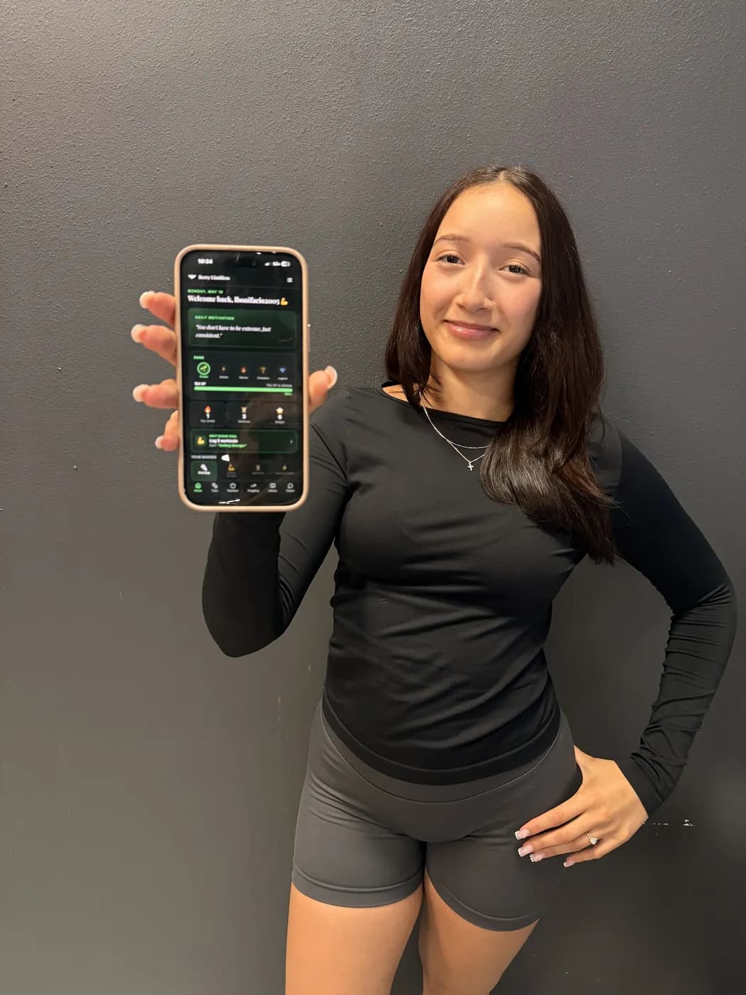 A member holding the Berry app