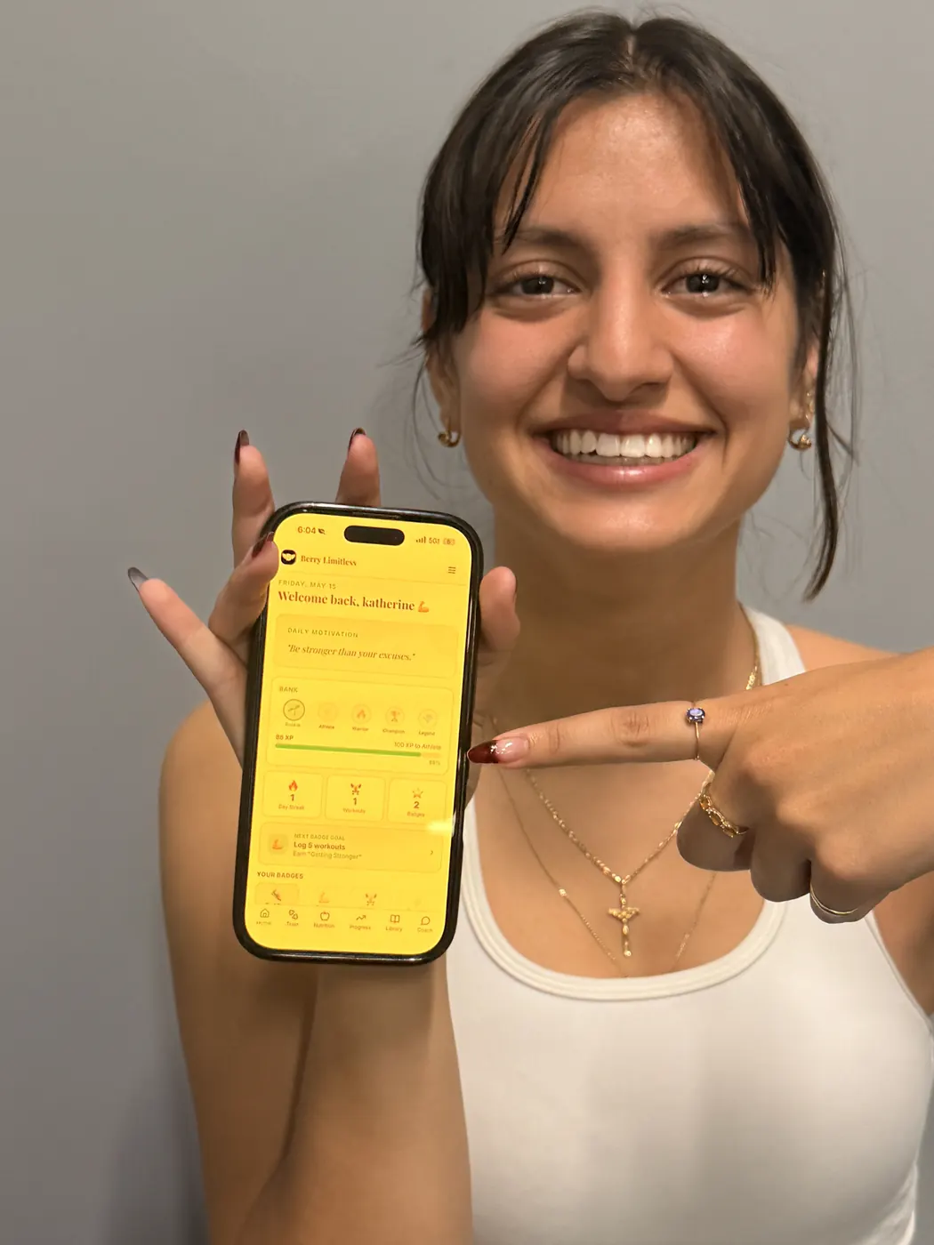 A smiling Berry Limitless member holding the Berry app